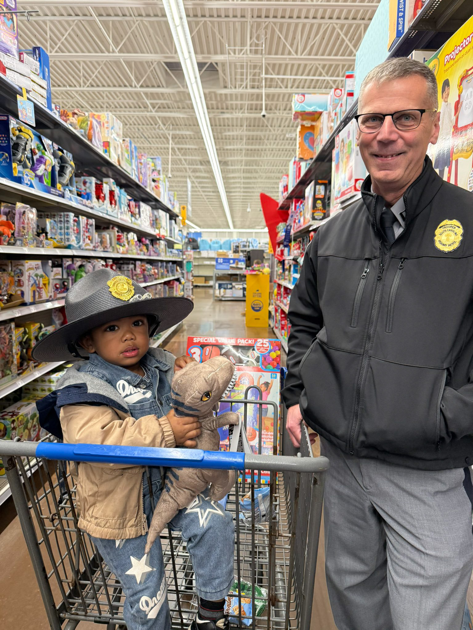 Captain Boniecki shopping with child during Shop with a Cop event