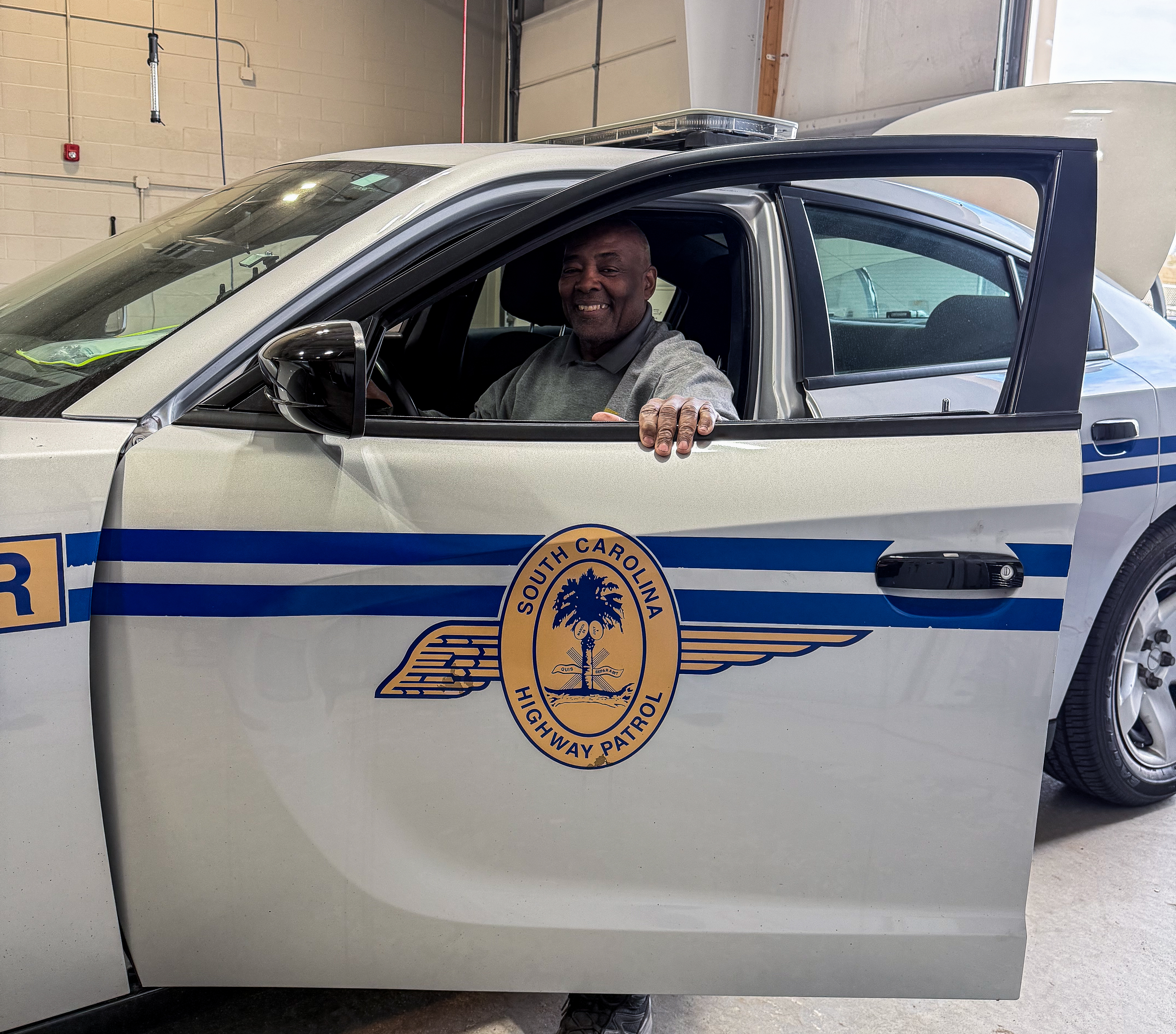 Wendell Walker sitting in a Highway Patrol vehicle