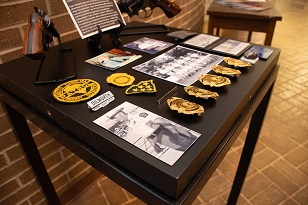 Artifacts from Dilworth's and Williams' combined 75 years of service guns, badges, patches, photos.