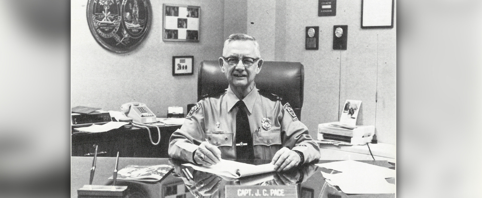 Captain Pace, Highway Patrol, at desk