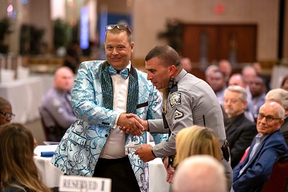 Knox shakes hands with a police officer