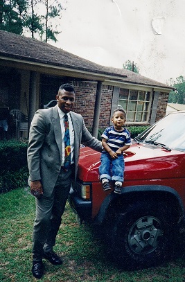 Patterson and his son are in front of their car